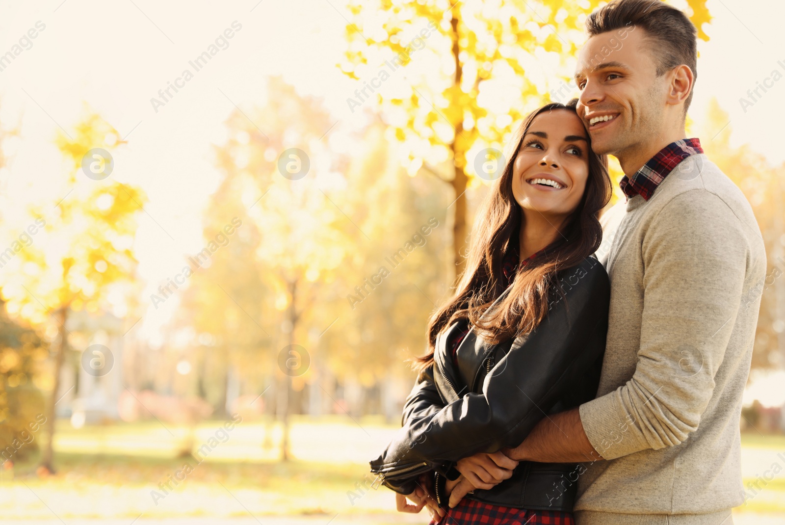 Photo of Happy couple in sunny park. Autumn walk