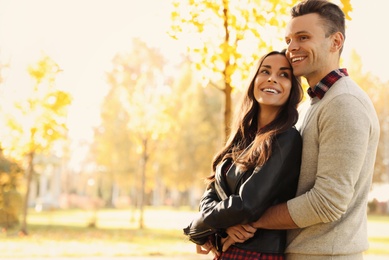 Happy couple in sunny park. Autumn walk