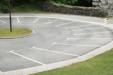 Photo of Empty outdoor parking lot with painted markings on asphalt