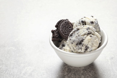 Bowl of chocolate cookies ice cream on table. Space for text