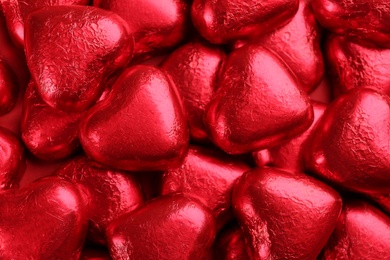 Photo of Heart shaped chocolate candies as background, top view