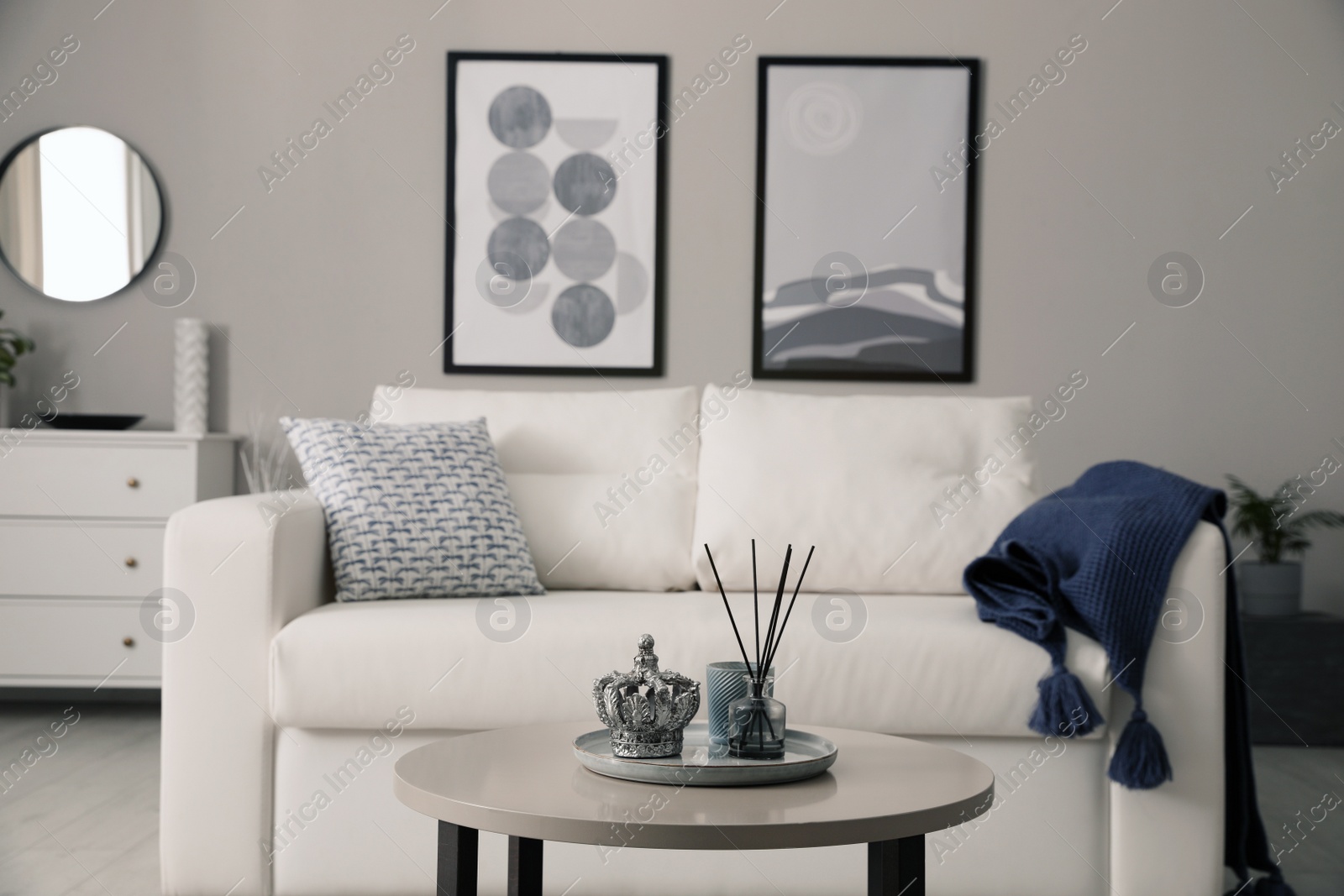 Photo of Stylish living room interior with white sofa and small coffee table