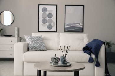 Stylish living room interior with white sofa and small coffee table