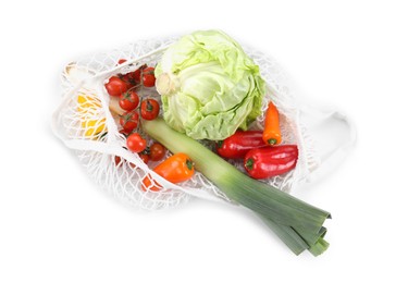 Photo of String bag with different vegetables isolated on white, top view