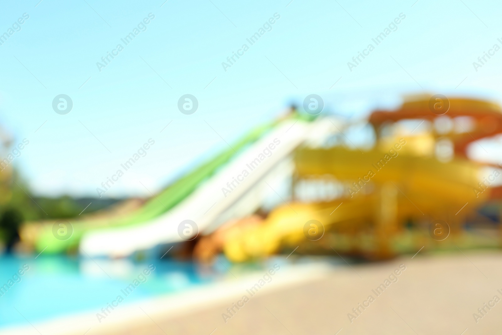 Photo of Different colorful slides in water park, blurred view