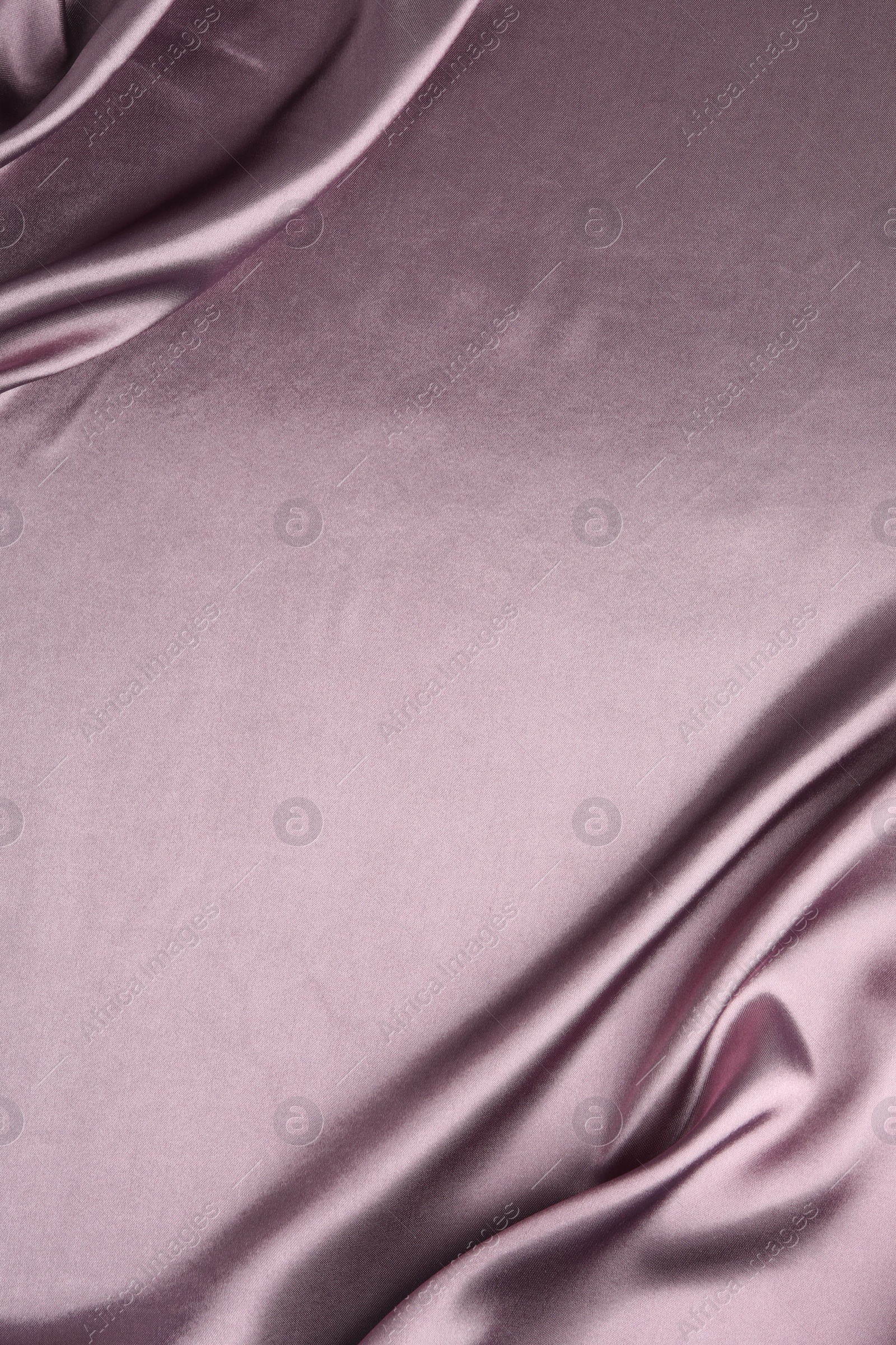 Photo of Crumpled dark purple silk fabric as background, top view. Space for text