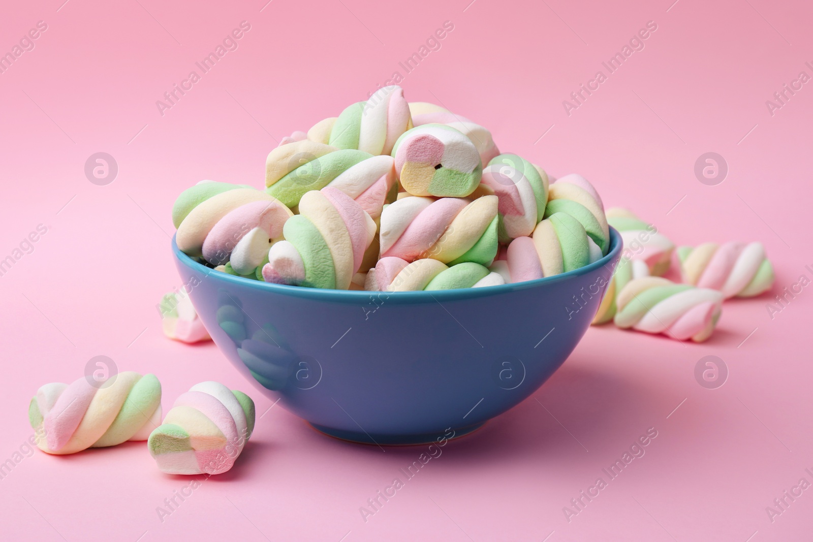 Photo of Bowl with delicious colorful marshmallows on pink background, closeup