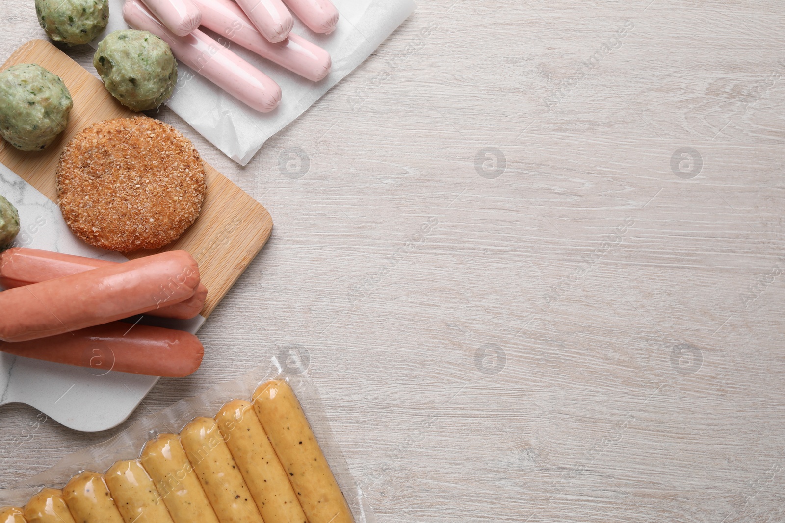 Photo of Different vegan products on white wooden table, flat lay. Space for text