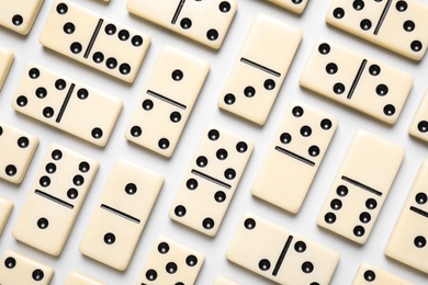 Photo of Classic domino tiles on white background, flat lay