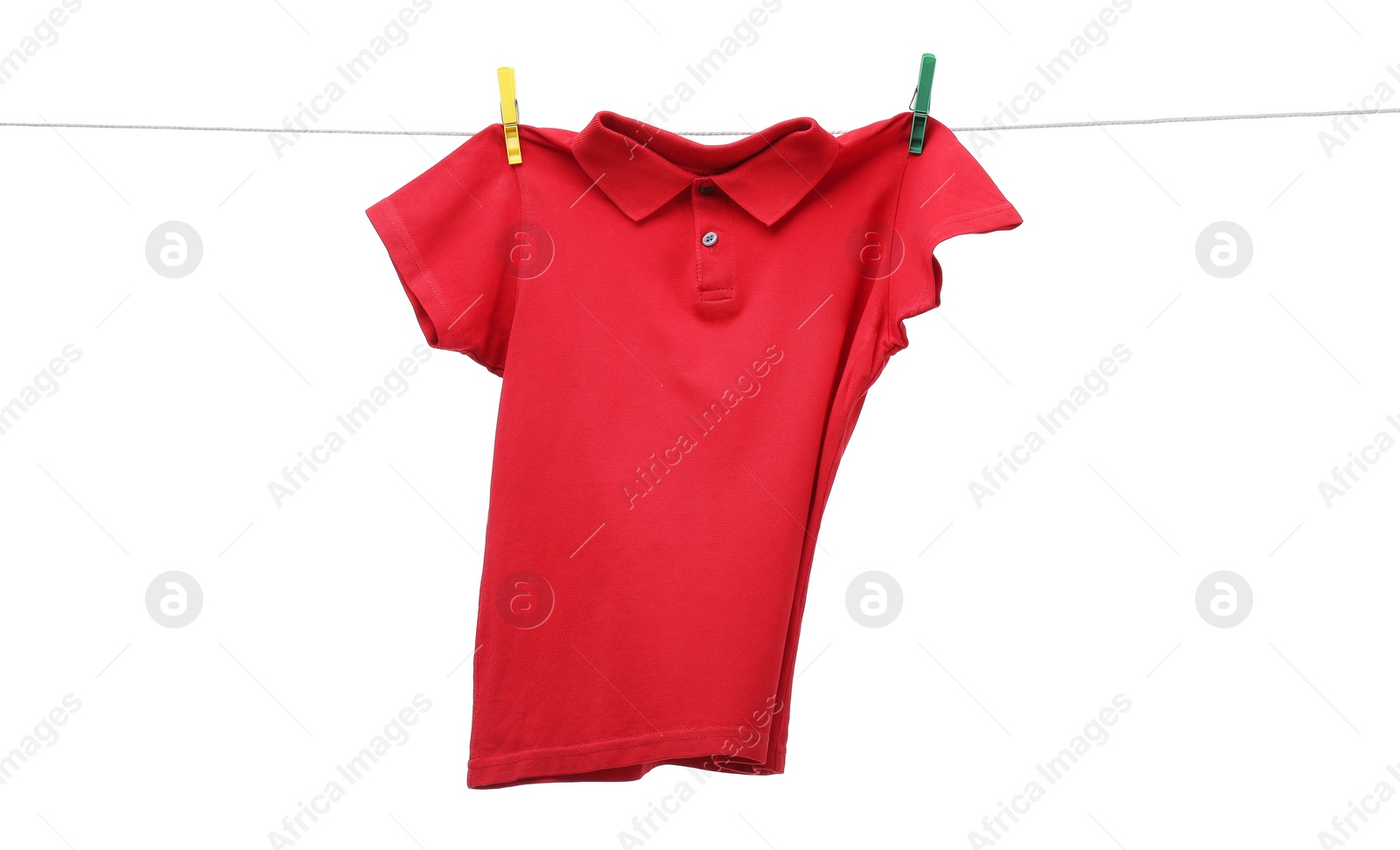 Photo of One red t-shirt drying on washing line isolated on white