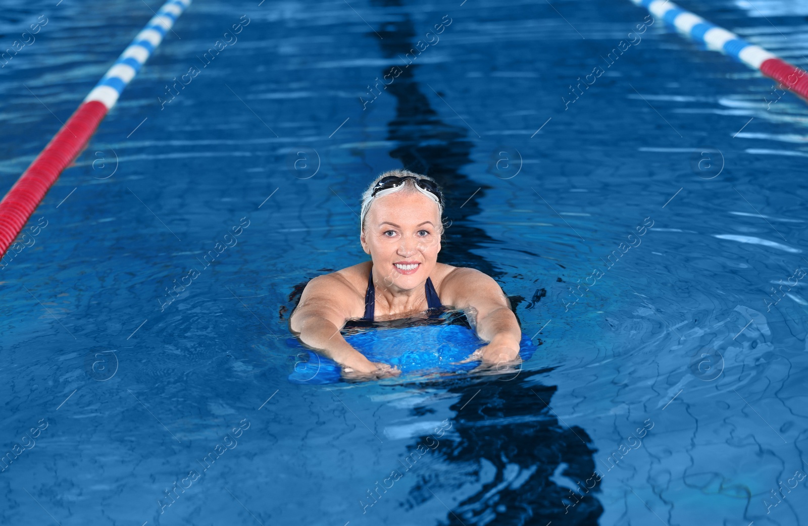 Photo of Sportive senior woman in indoor swimming pool