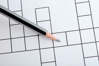 Pencil on blank crossword, top view. Space for text