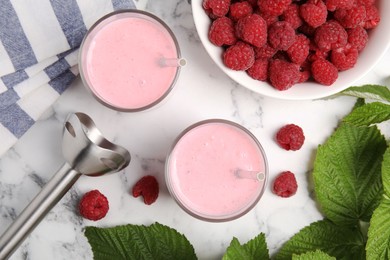 Tasty fresh raspberry smoothie on white marble table, flat lay