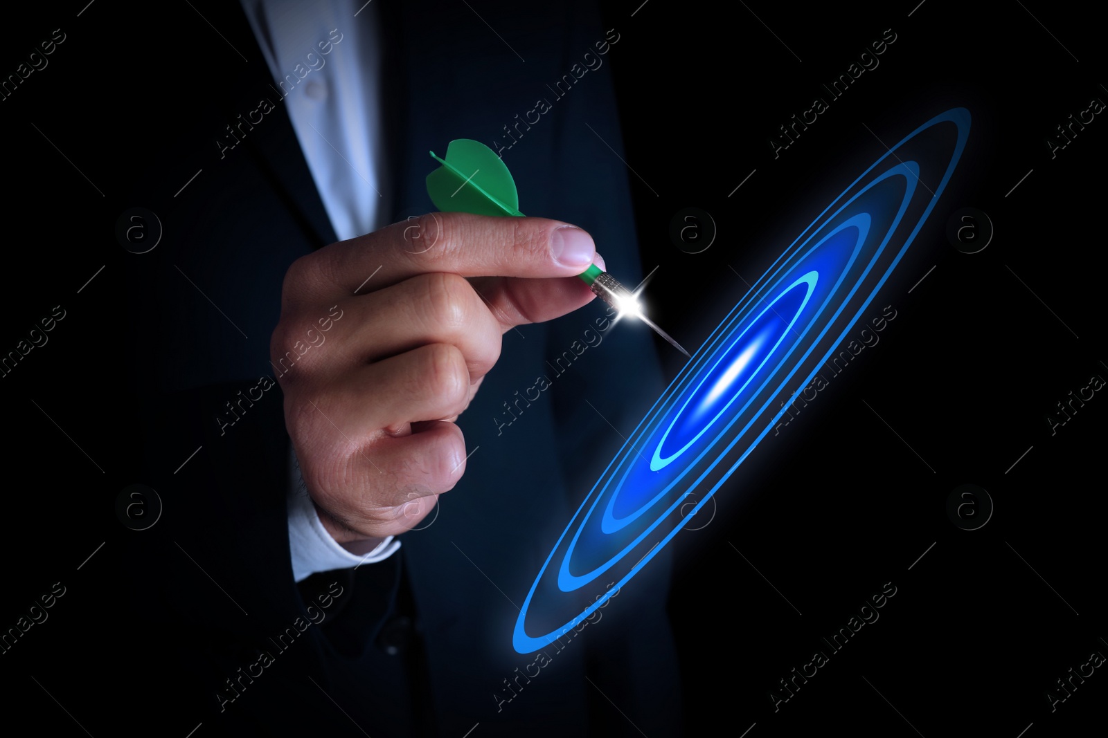 Image of Businessman aiming at digital target with dart against dark background, closeup