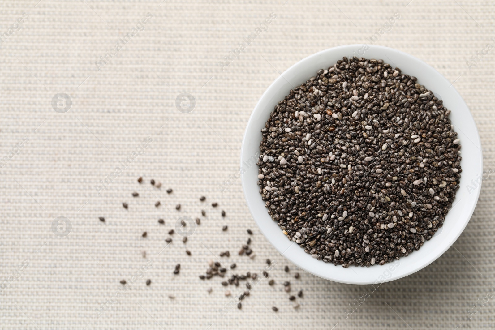 Photo of Bowl with chia seeds on table, flat lay. Space for text