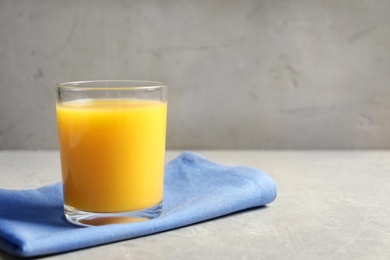 Glass of orange juice on table