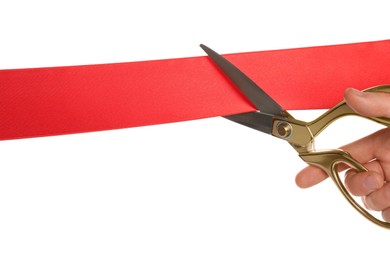 Man cutting red ribbon on white background, closeup