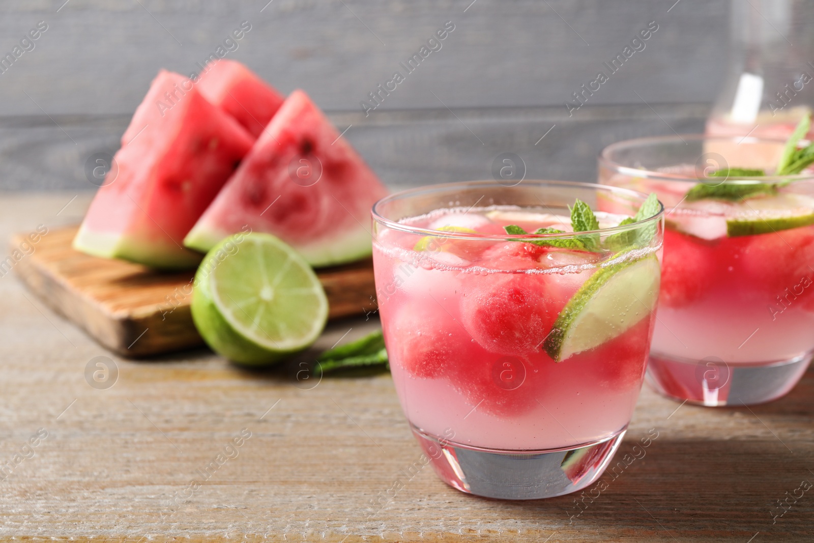 Photo of Tasty refreshing watermelon drink on wooden table