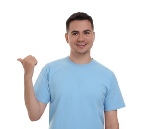 Special promotion. Happy man pointing at something on white background