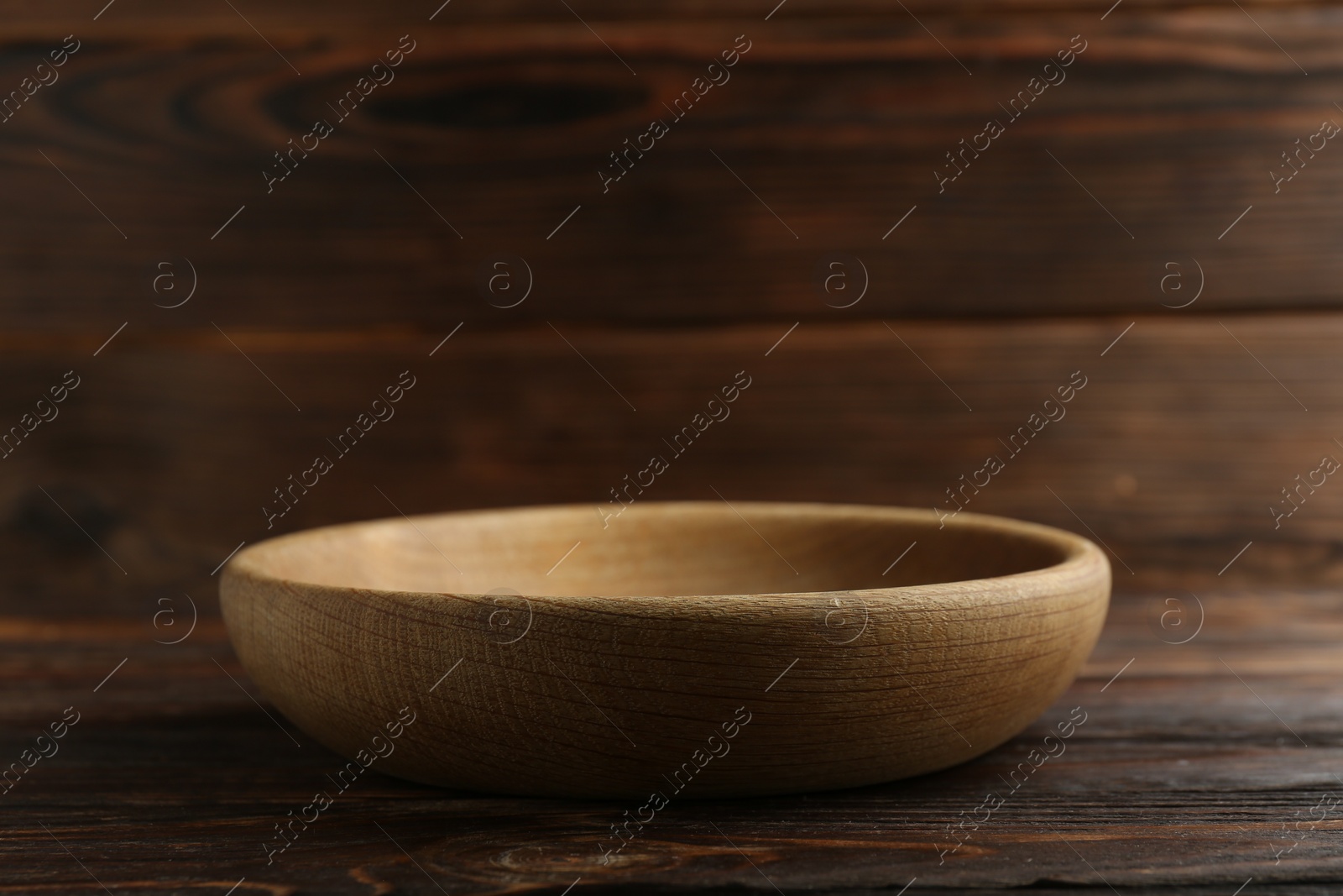 Photo of Beautiful bowl on wooden table, closeup. Space for text