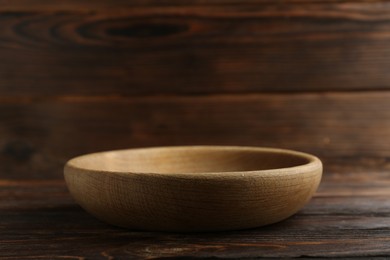 Beautiful bowl on wooden table, closeup. Space for text