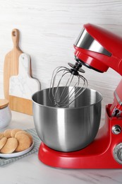 Photo of Modern red stand mixer and cookies on white marble table