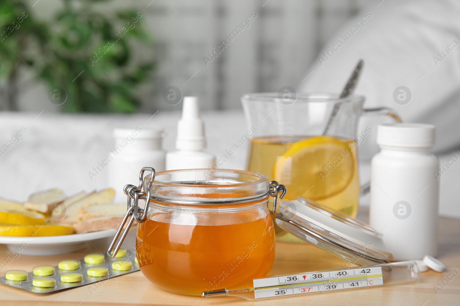 Photo of Honey and different cold remedies on wooden table