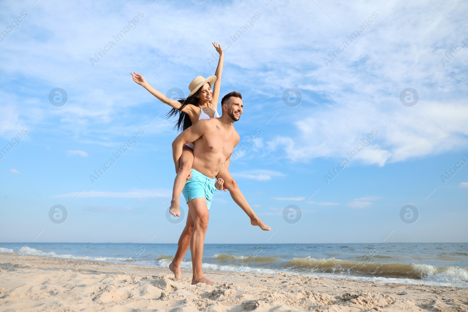 Photo of Happy young couple having fun on beach