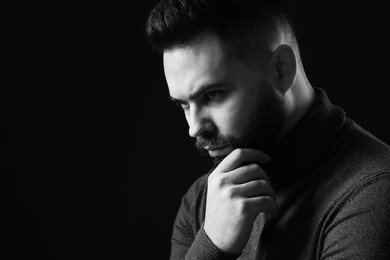 Photo of Portrait of handsome bearded man on dark background, space for text. Black and white effect