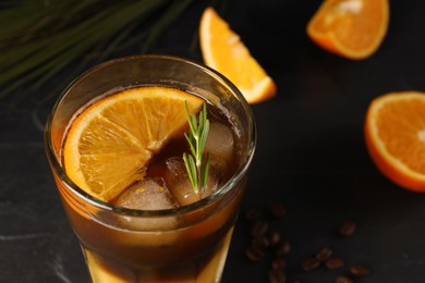 Photo of Tasty refreshing drink with coffee and orange juice on grey table, closeup