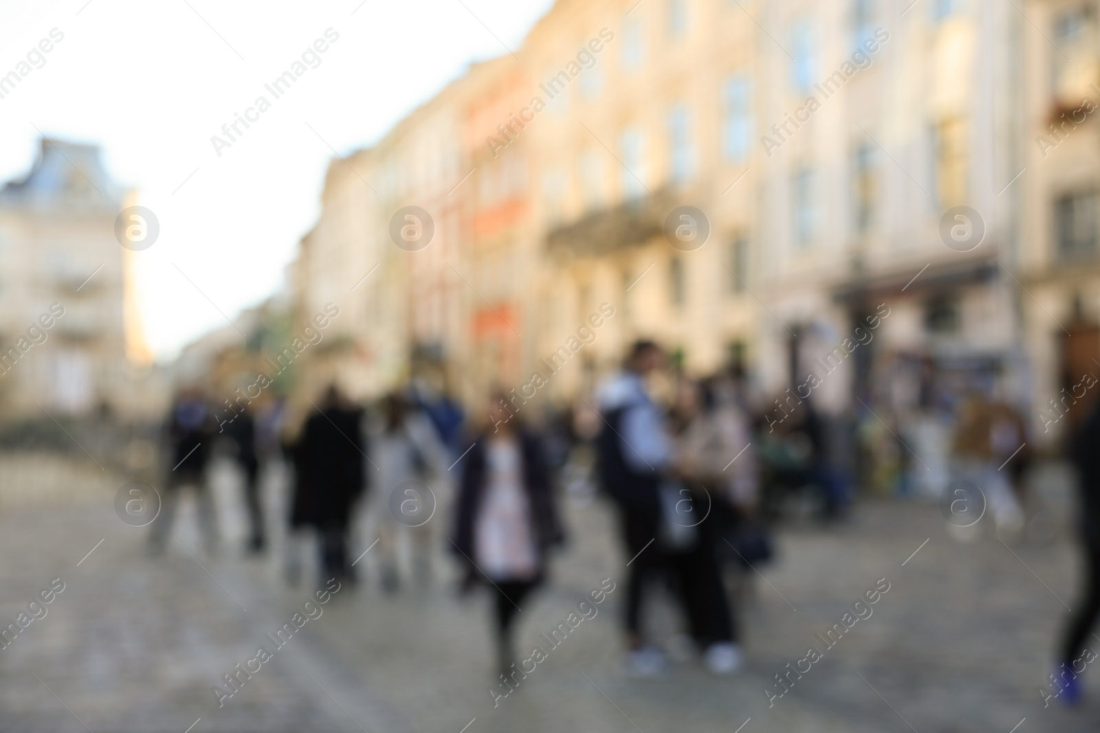 Photo of Blurred view of people walking on city street