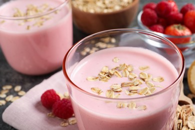 Photo of Tasty berry smoothie with oatmeal on table, closeup