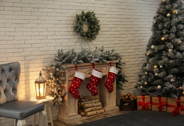 Photo of Stylish Christmas interior with decorated fir tree and fireplace