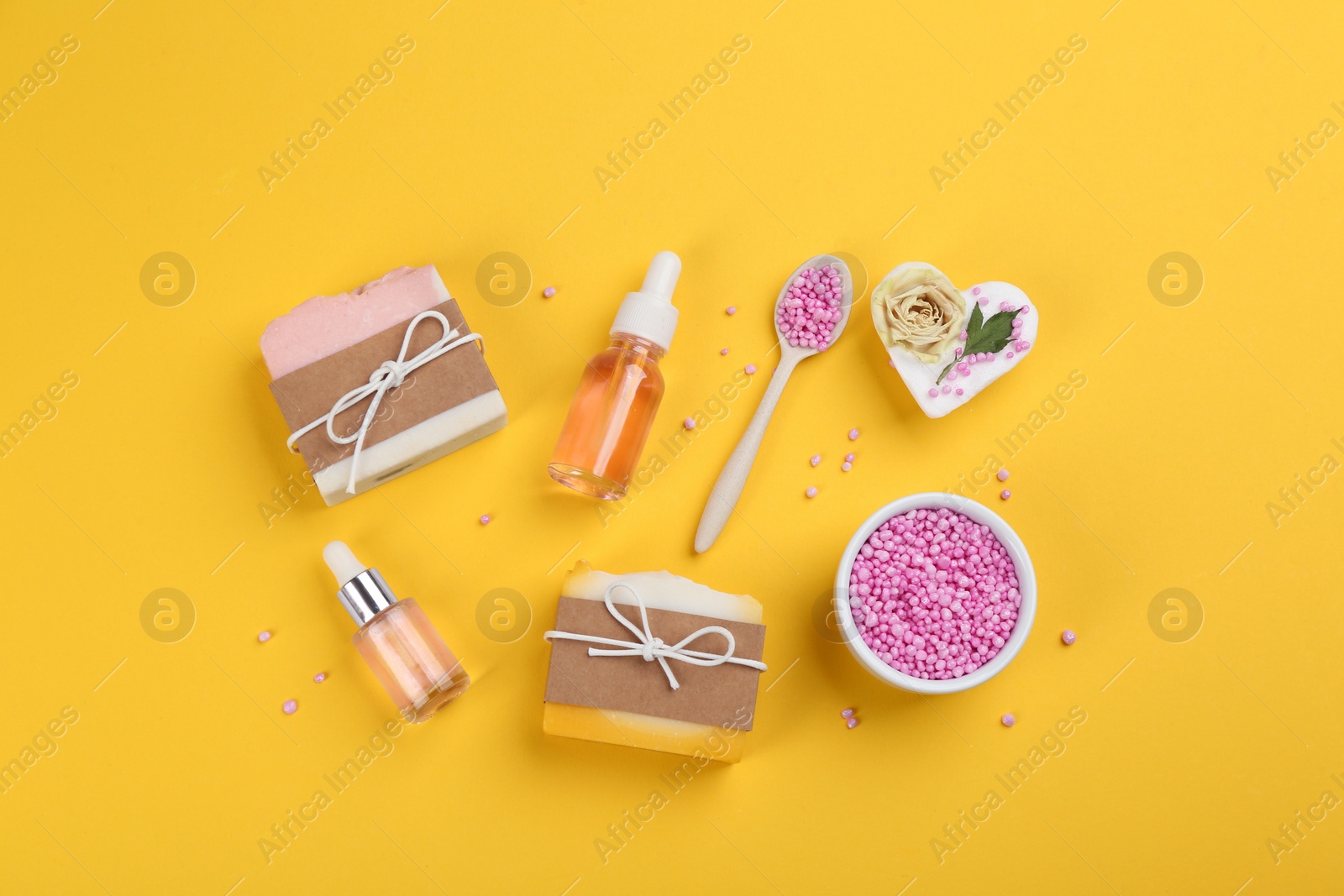 Photo of Flat lay composition with natural handmade soap on yellow background