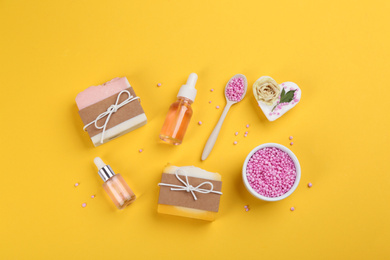 Flat lay composition with natural handmade soap on yellow background