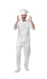 Photo of Happy chef in uniform showing OK gesture on white background