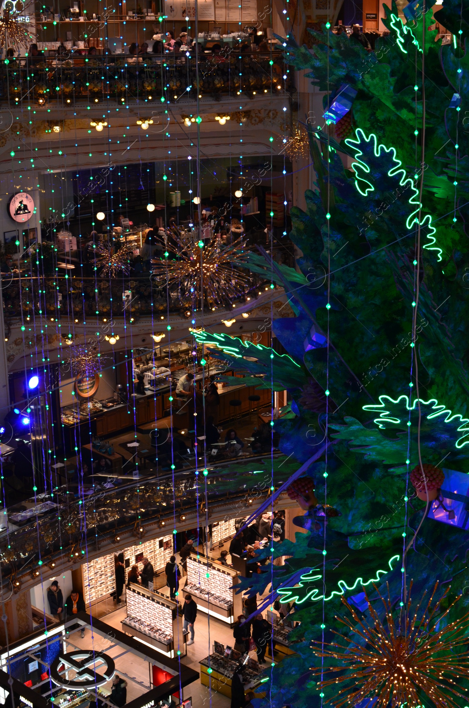 Photo of Paris, France - December 10, 2022: Crowded Galeries Lafayette Haussmann with beautiful Christmas decor