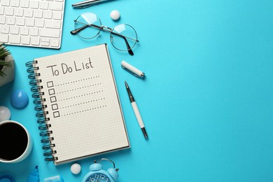 Photo of Flat lay composition with unfilled To Do list and cup of coffee on light blue background, space for text