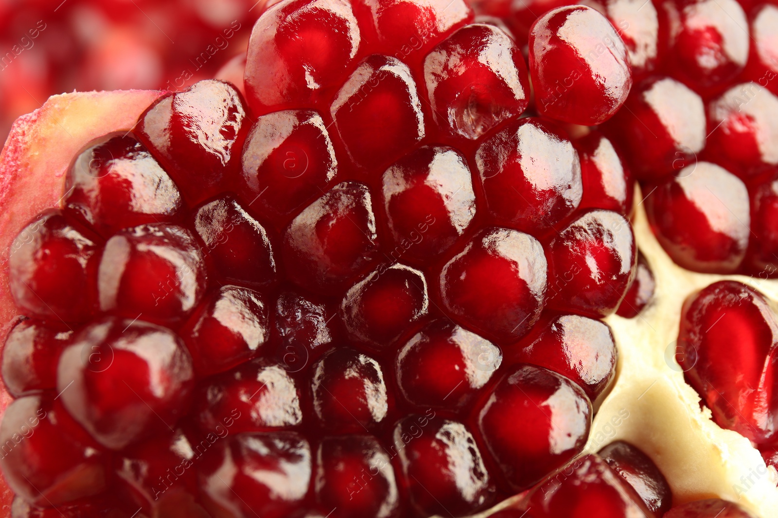 Photo of Ripe juicy pomegranate grains as background, closeup