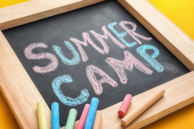 Photo of Text "SUMMER CAMP" on small blackboard and chalk, closeup