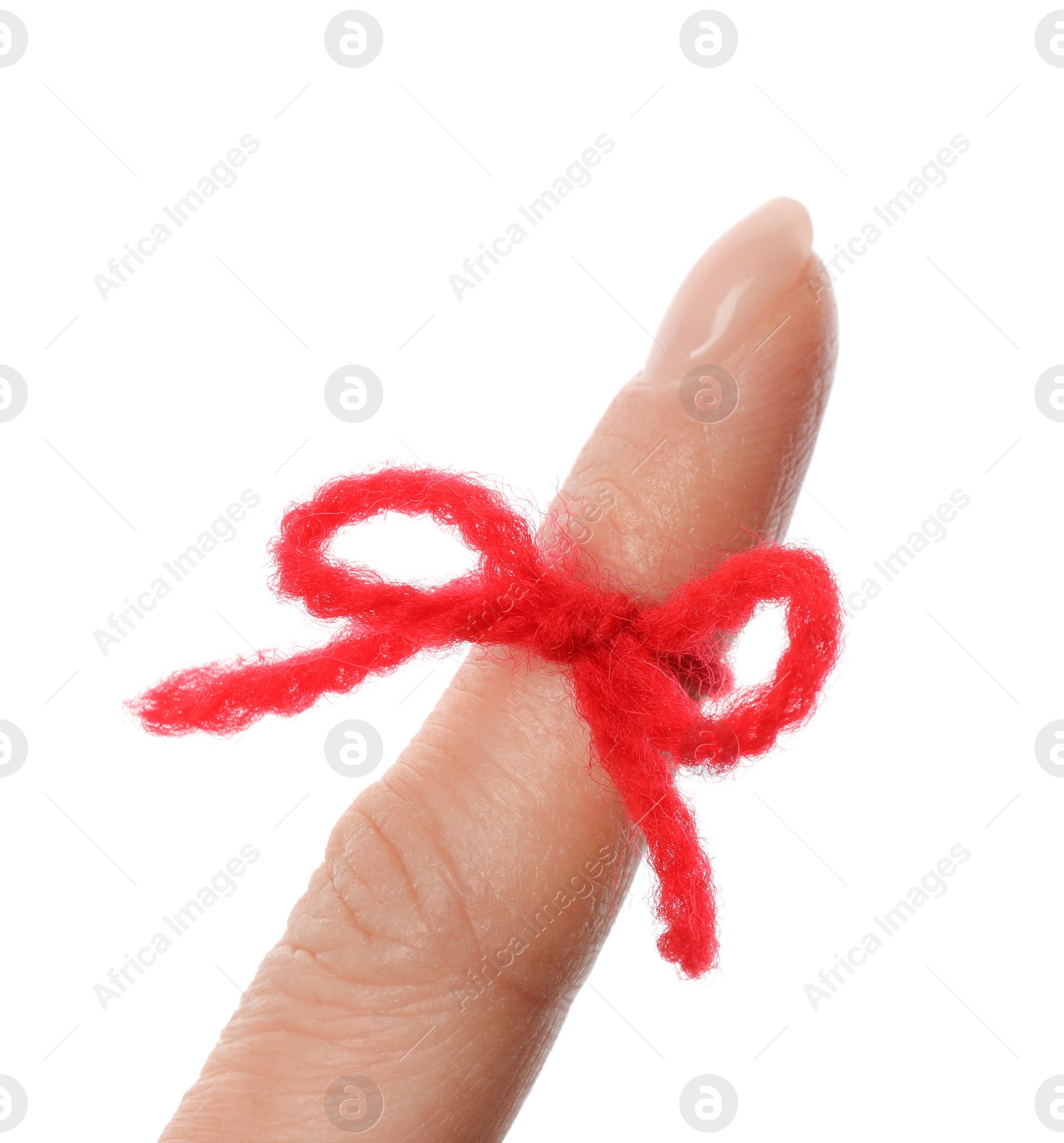 Photo of Woman showing index finger with tied red bow as reminder on white background, closeup