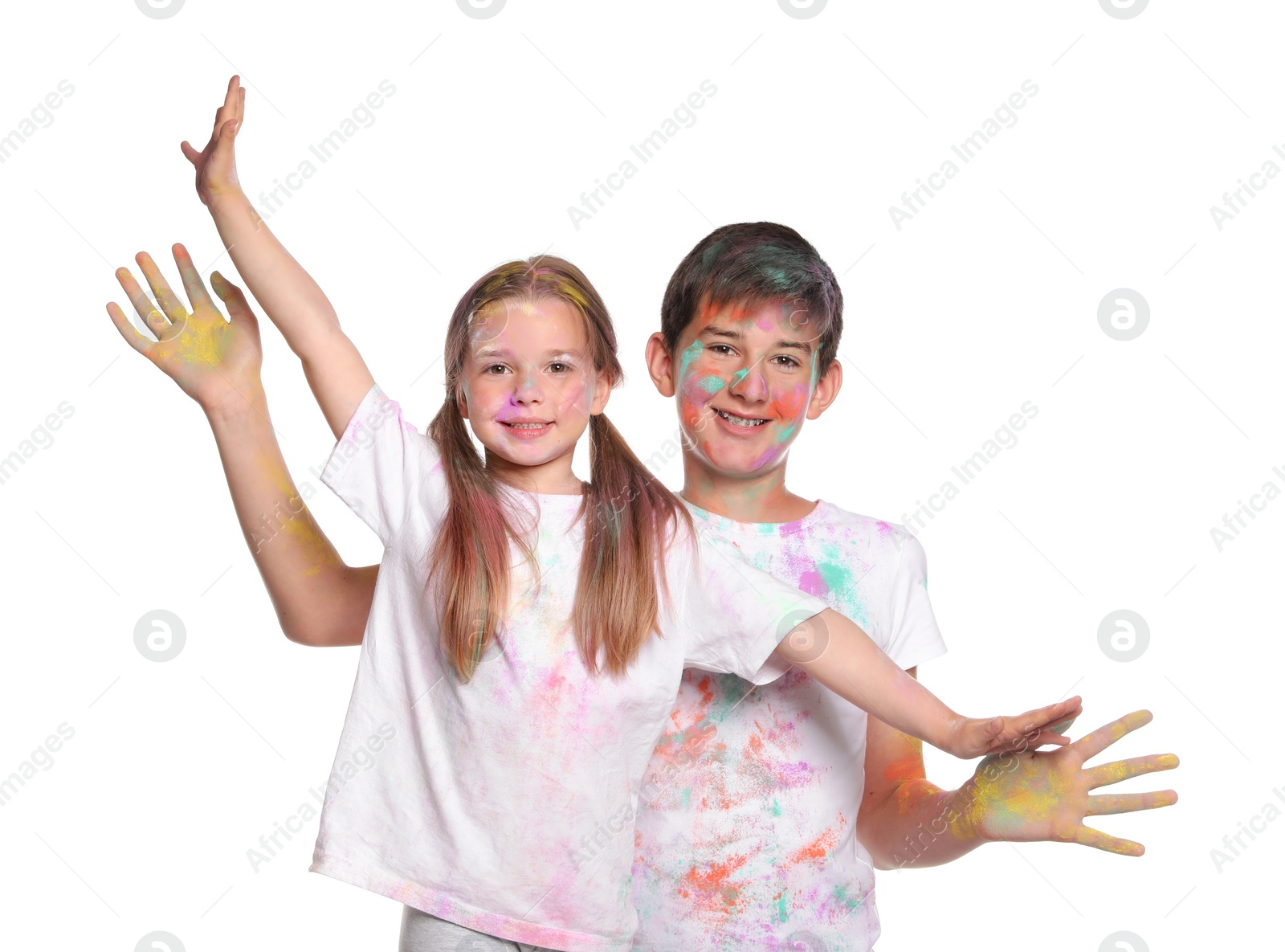 Photo of Friends covered with colorful powder dyes on white background. Holi festival celebration