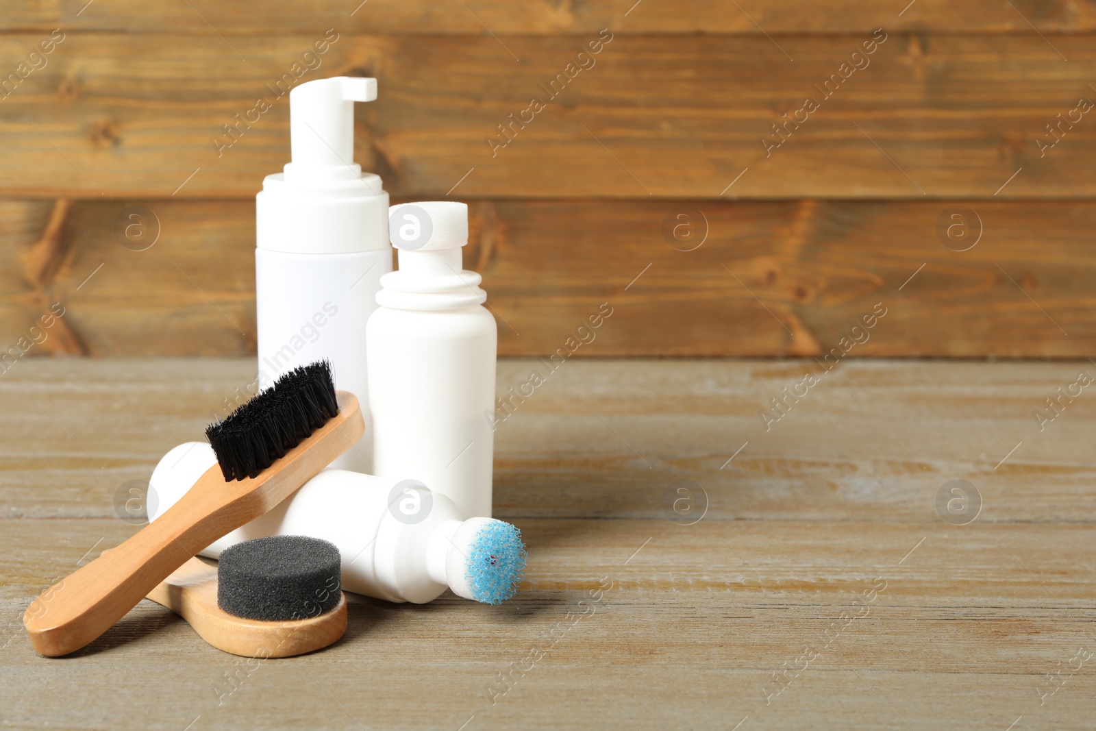 Photo of Composition with shoe care accessories on wooden table, space for text