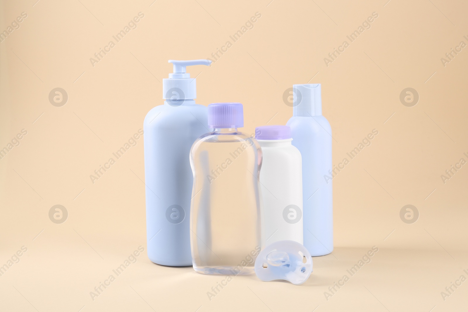 Photo of Different skin care products for baby and pacifier on beige background