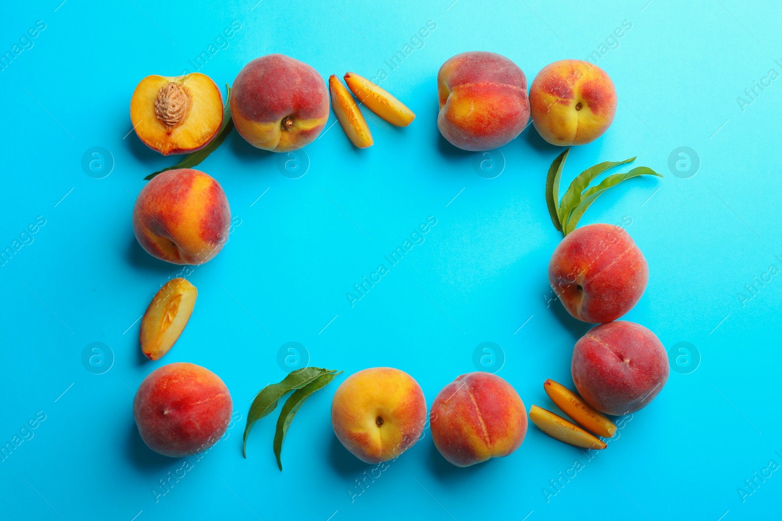 Photo of Flat lay composition with fresh peaches on blue background. Space for text