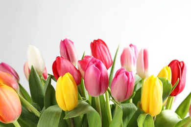 Photo of Beautiful bouquet of bright tulip flowers on white background