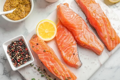 Fresh salmon and ingredients for marinade on table, top view