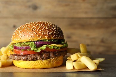 Photo of Burger with delicious patty and french fries on table, closeup