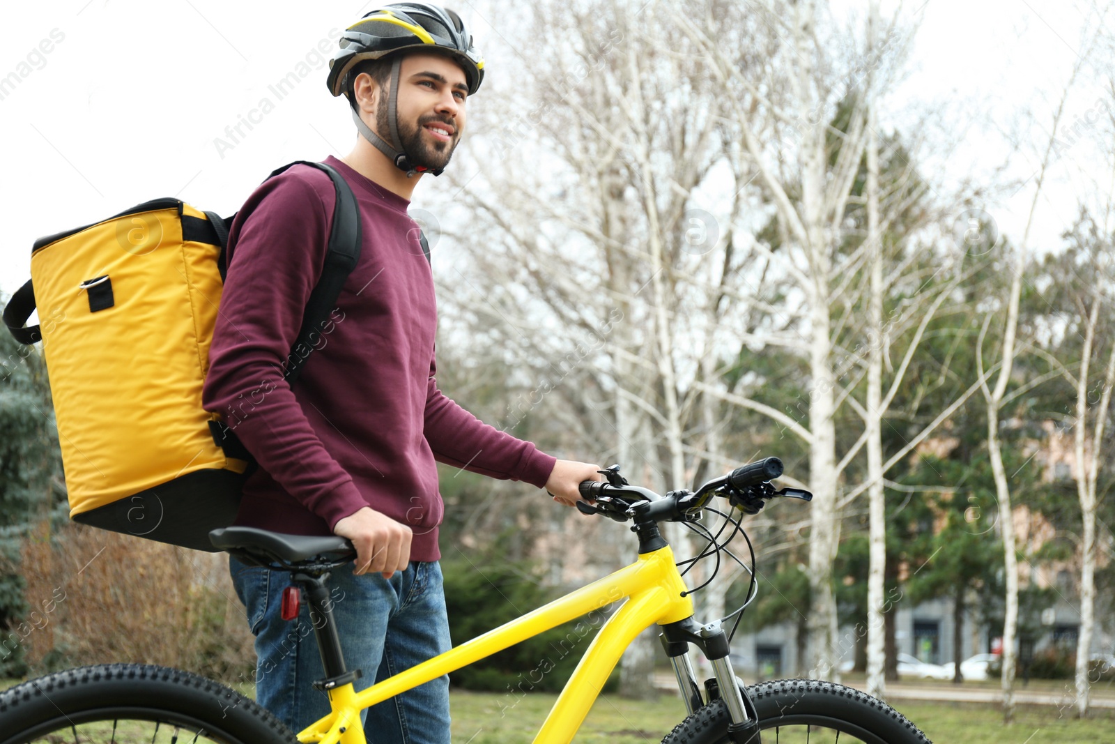 Photo of Courier with thermo bag and bicycle outdoors. Food delivery service