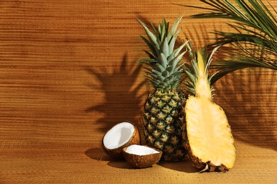 Fresh pineapples and coconut on bamboo mat